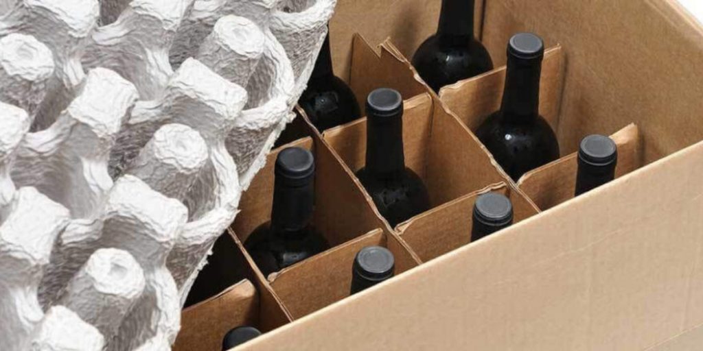 Temperature controlled wine shipping displays wine bottles secured in individual cardboard compartments with protective foam padding material for safe insulated transport.
