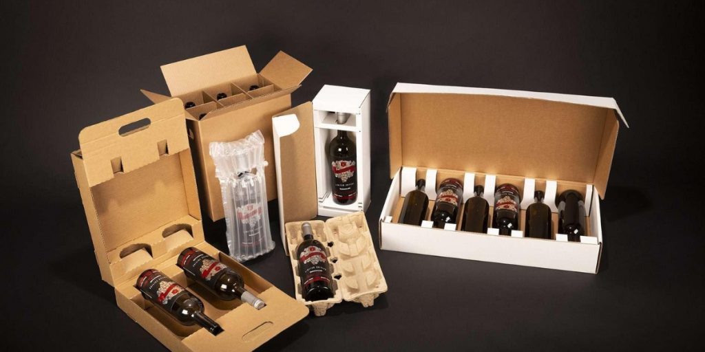 Various wine bottle shipping box designs with foam inserts, bubble wrap, and tissue paper cushioning displayed against a dark background, showcasing different methods of how we protect wine bottles during shipping.